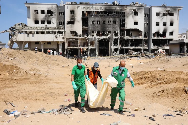 Palestinian forensic and civil defence recover human remains at the grounds of Al-Shifa hospital after it was destroyed a two-week Israeli raid, on April 8, 2024.